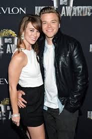 Brett Davern was captured  with his wife Tricia Vansant in a smiley face wearing black leather jacket and white t-shirt 
